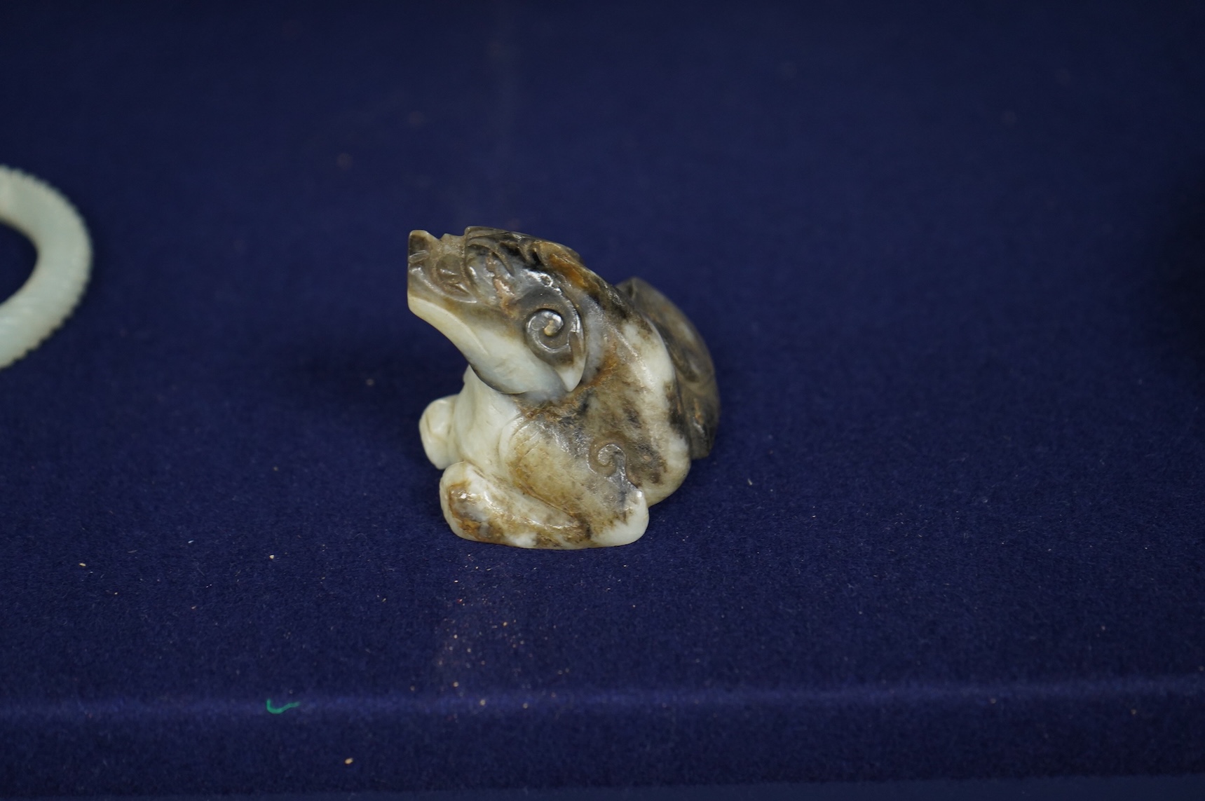 A Chinese white and black jade mythical beast, 5cm wide